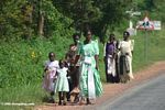 Women and children dressed up and walking home from church on a Sunday in Uganda