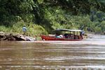 Motorized canoe filled ith cargo on the Rio Tambopata in Peru