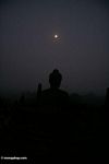 Silhouetted Dhyani buddha of Boboudur at daybreak (Java)
