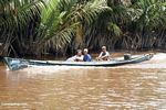 Men in long boat on the Seikonyer River (Kalimantan, Borneo (Indonesian Borneo)) 