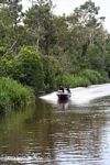 Speedboat carrying silica and gold miners on the Seikonyer River (Kalimantan, Borneo (Indonesian Borneo)) 