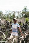 Thomas standing among charred jungle remains in Borneo (Kalimantan, Borneo (Indonesian Borneo)) 