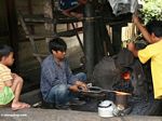 Blacksmiths hammering white-hot metal for machetes (Toraja Land (Torajaland), Sulawesi) 
