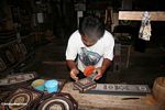 Toraja man painting carved wooded boxes at Keta Kese (Toraja Land (Torajaland), Sulawesi) 