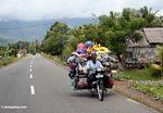 Vendor carrying all of his wares on the back of his motorbike (Sulawesi (Celebes))