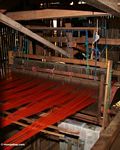 Red-orange silk be woven in a loom (Sulawesi (Celebes))