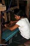 Woman weaving a turquoise silk piece (Sulawesi (Celebes))