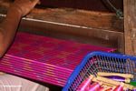Woman weaving a magenta silk piece-detail (Sulawesi (Celebes))