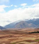 Snow-capped mountains in the Andes with agricultural fields in the foreground